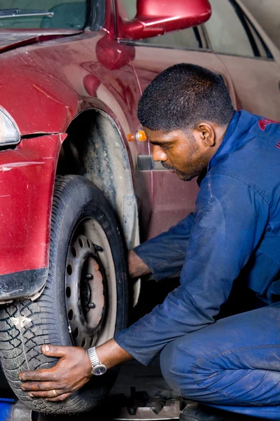 Mechanic changing vehicle tyre