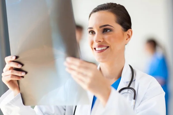 Happy medical doctor looking at x-ray film