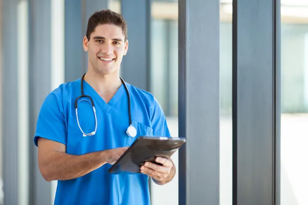 Happy male healthcare worker with tablet computer