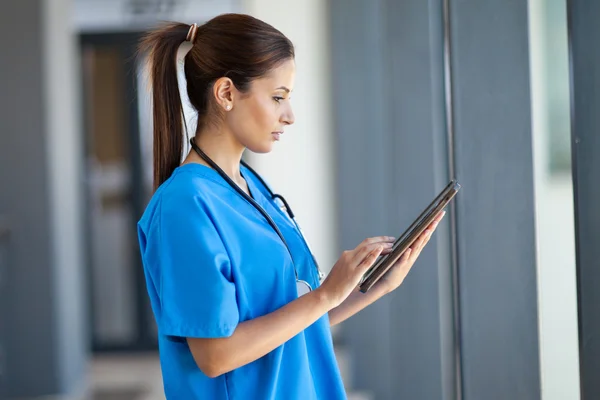 Female nurse using tablet computer in hospital