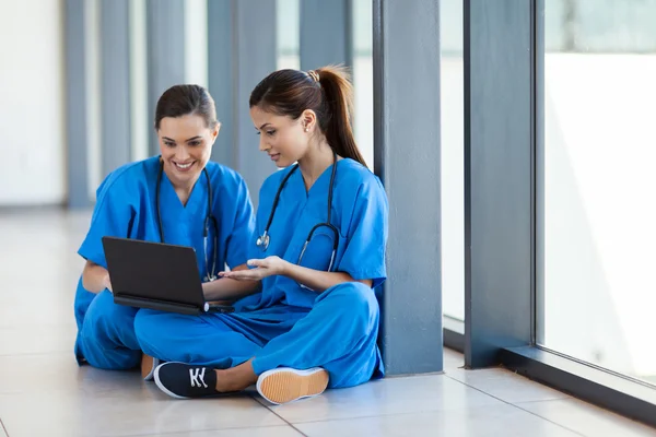 Two nurses using laptop computer during break
