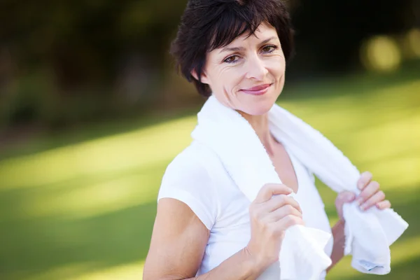 Elegant middle aged woman relaxing after workout