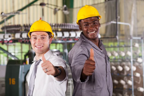 Happy factory foreman and worker thumbs up