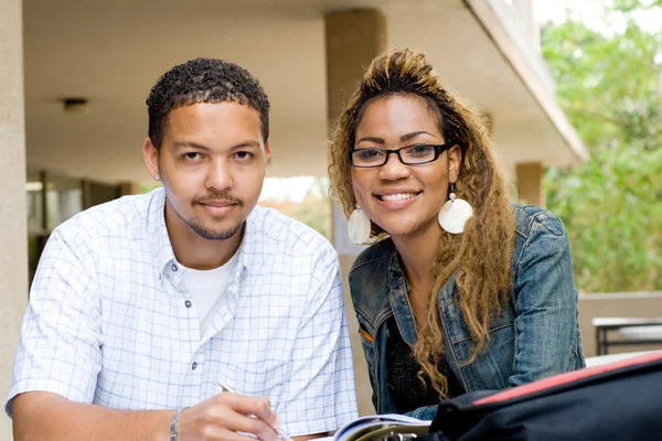 Two african american college students studying together