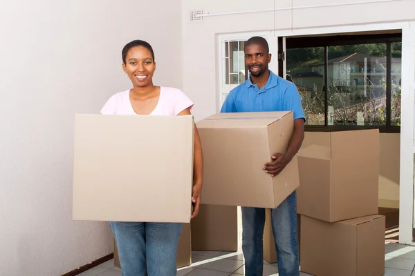 Happy african american couple moving in new home