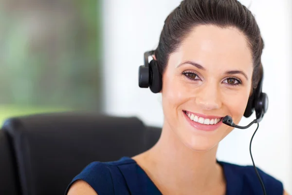 Cute young business call center operator with headphones