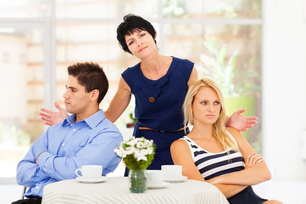 Middle aged mother feeling helpless when caught in between young couple\'s fight
