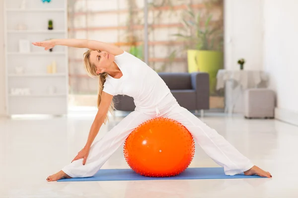 Fit middle aged woman workout with exercise ball