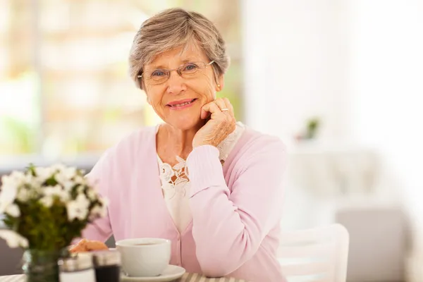 Elegant senior woman having tea