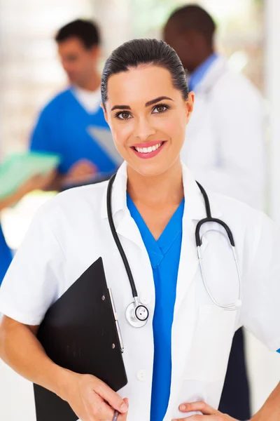 Pretty female medical worker in front of colleagues