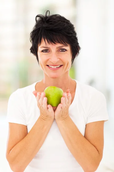 Woman holding a green apple