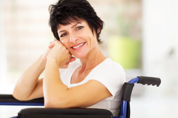 Middle aged woman sitting on wheelchair