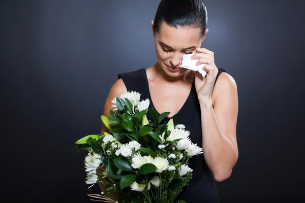 Sad woman in mourning clothes crying