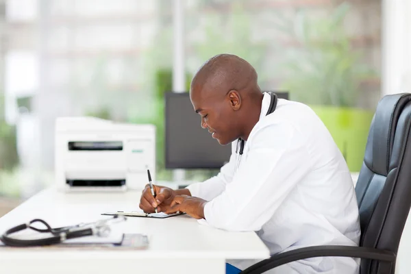 African medical doctor writing reports