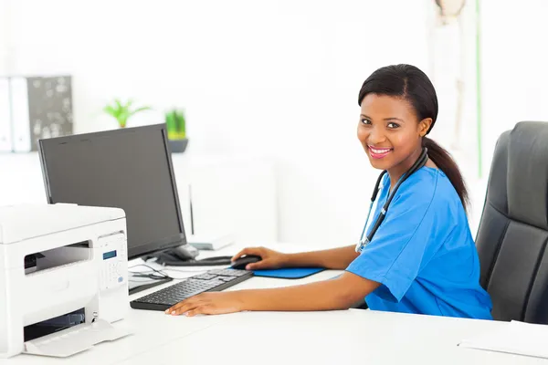 Afro american female doctor sitting in her office