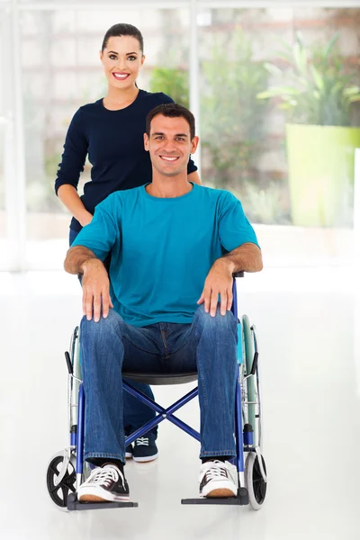 Handicapped man and caring wife at home