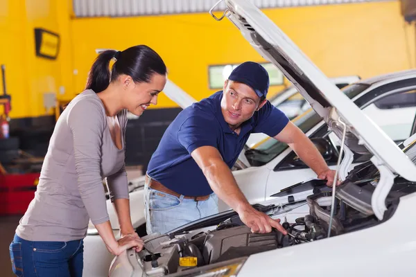 Mechanic showing customer car problem