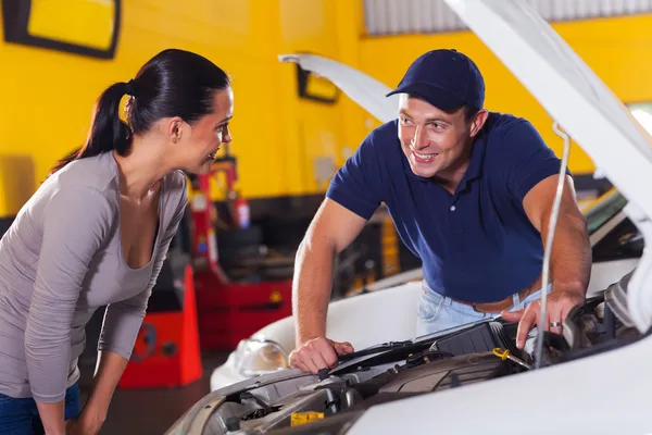 Auto technician talking to customer