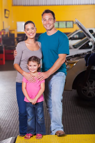 Happy family in car service center