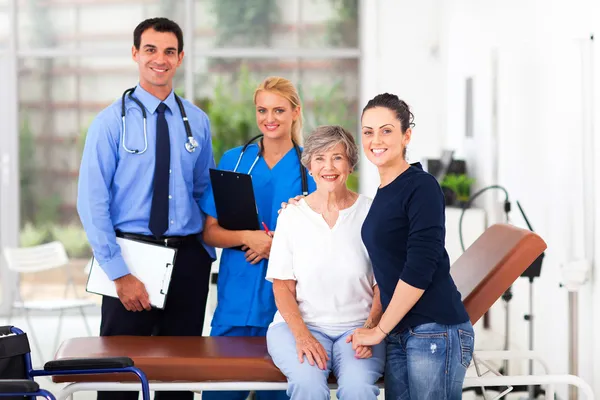 Elderly patient and her daughter in hospital with doctor and nur