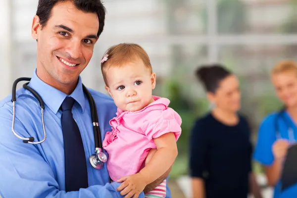 Pediatrician holding baby patient