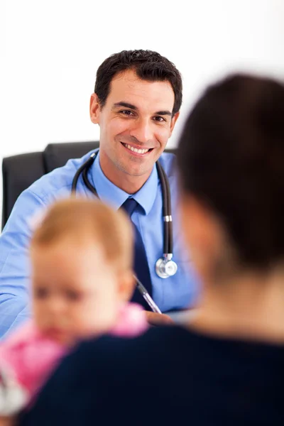 Pediatrician talking to baby\'s mother