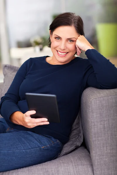 Middle aged woman using tablet computer