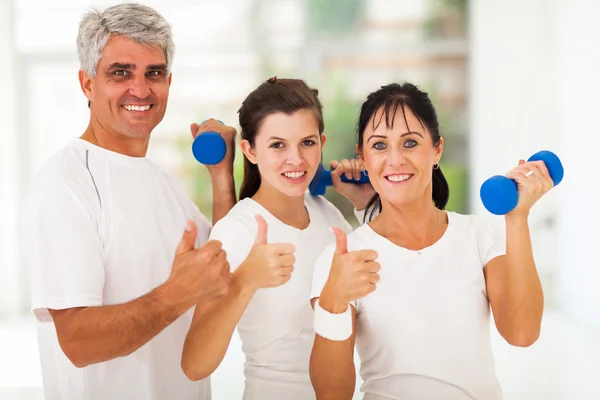 Healthy family giving thumbs up