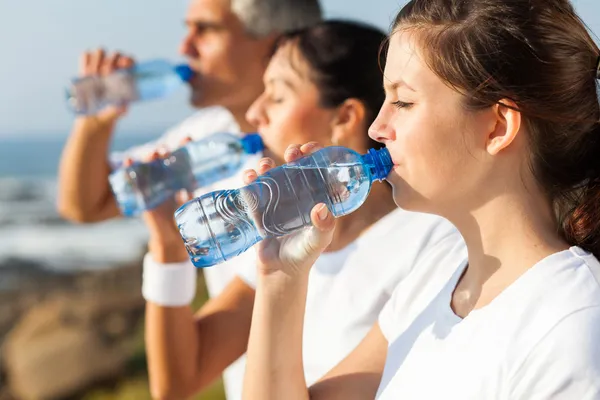Active family drinking water after jogging