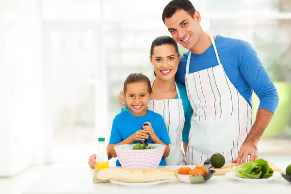 Adorable young family cooking at home