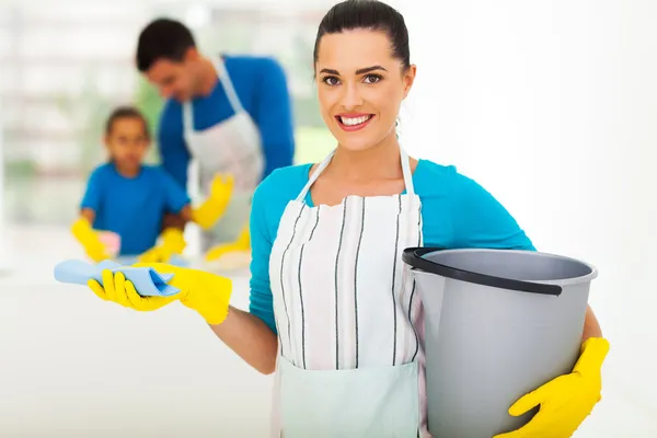 Young woman with cleaning tools