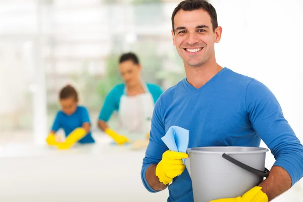 Happy family man cleaning home with family