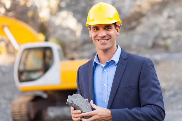 Manager in mining site holding ore