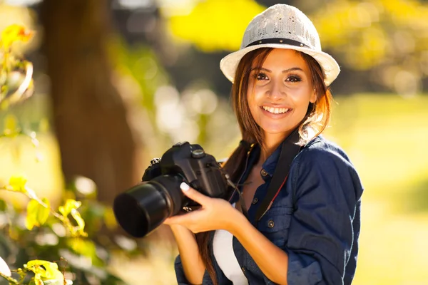 Beautiful female student photographer with camera