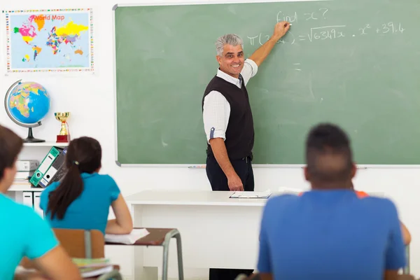 Middle aged teacher teaching mathematics