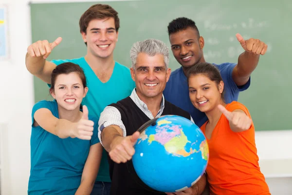 High school students and senior teacher giving thumbs up