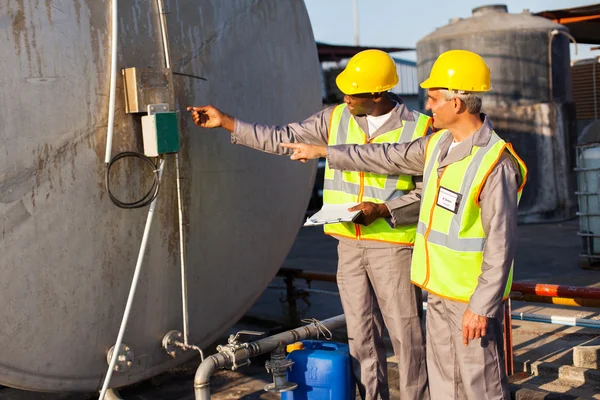 Industrial engineers inspecting fuel tank