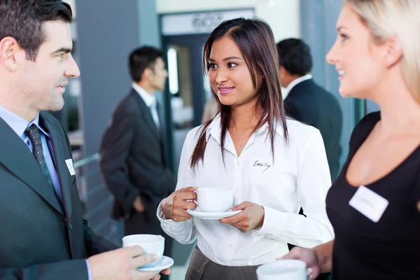 Businesspeople interacting during conference coffee break