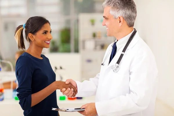 Doctor handshaking with young patient