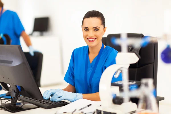 Medical researcher working on computer in laboratory