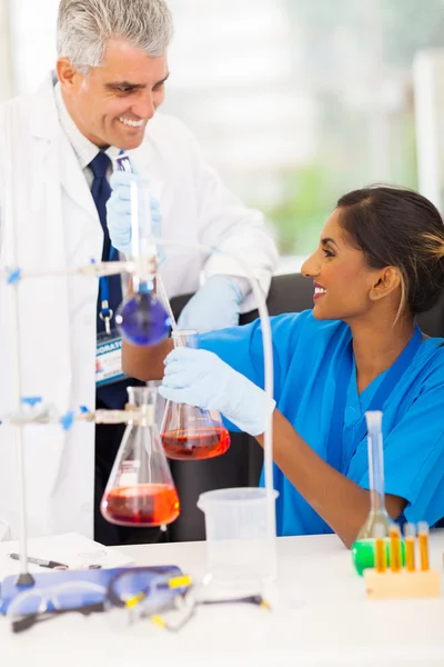 Professor and university student in the chemical laboratory