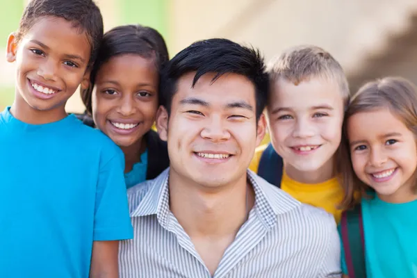 Happy teacher with primary school students