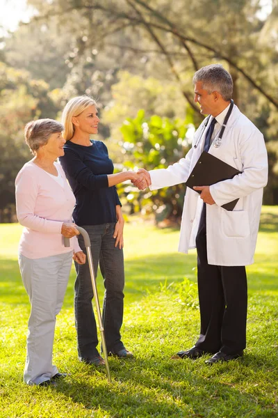 Retirement village docotr greeting senior patient's daughter