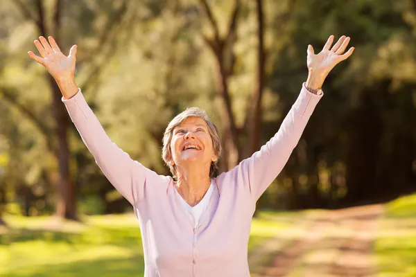 Healthy elderly woman arms outstretched