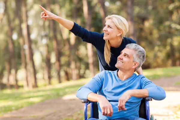 Loving mid age wife taking injured husband for a walk