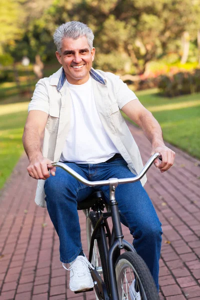 Middle aged man riding a bike