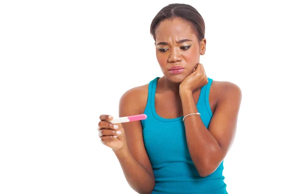 Sad afro american woman looking at pregnancy test — Stock Photo #29952255
