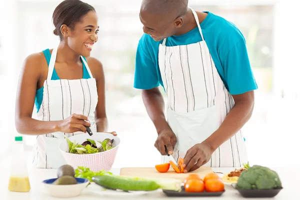 African husband and wife cooking dinner together