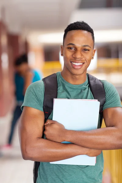 African american college student holding books