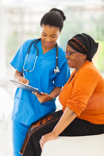 Young african nurse explaining medical test result